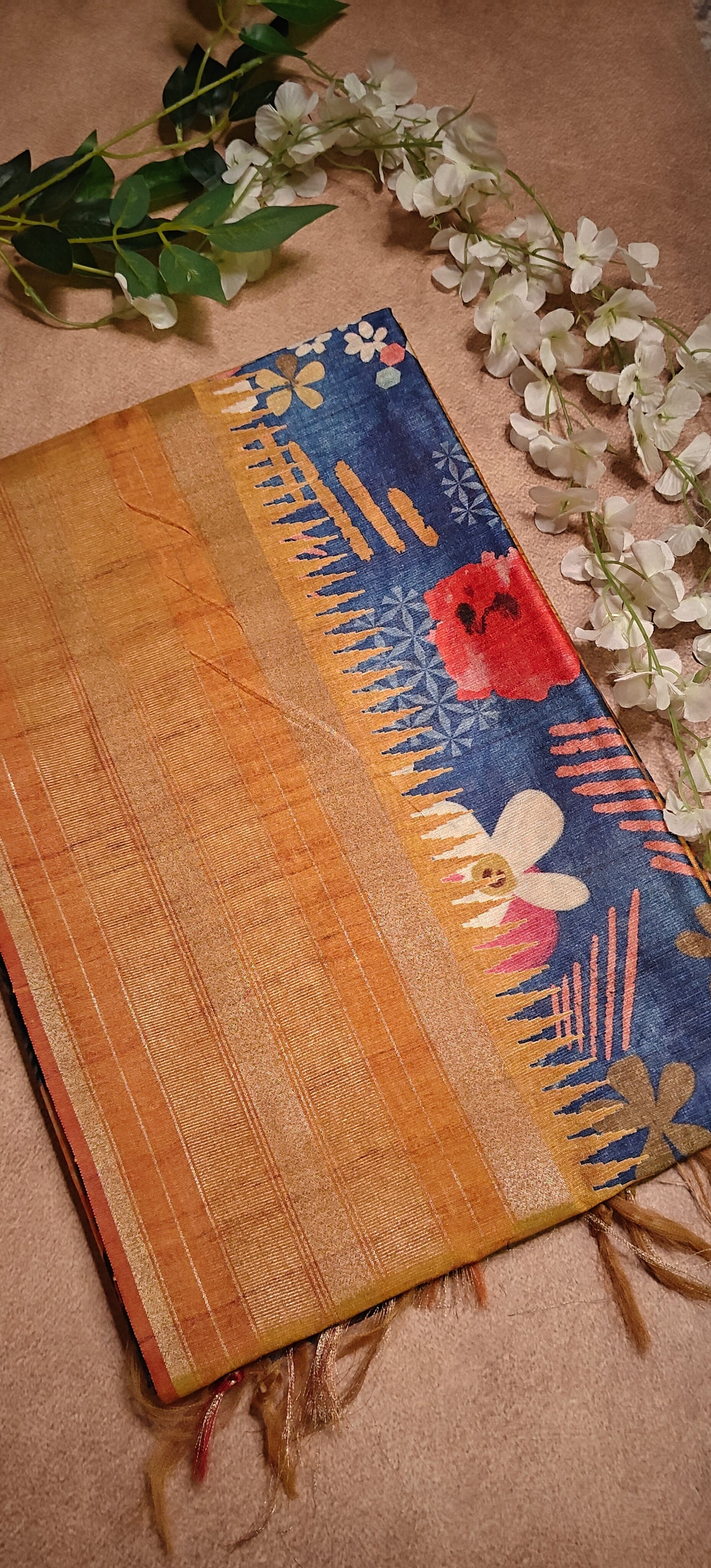 Blue Silk Blend Saree with Mustard border and digital floral print on a textured surface.
