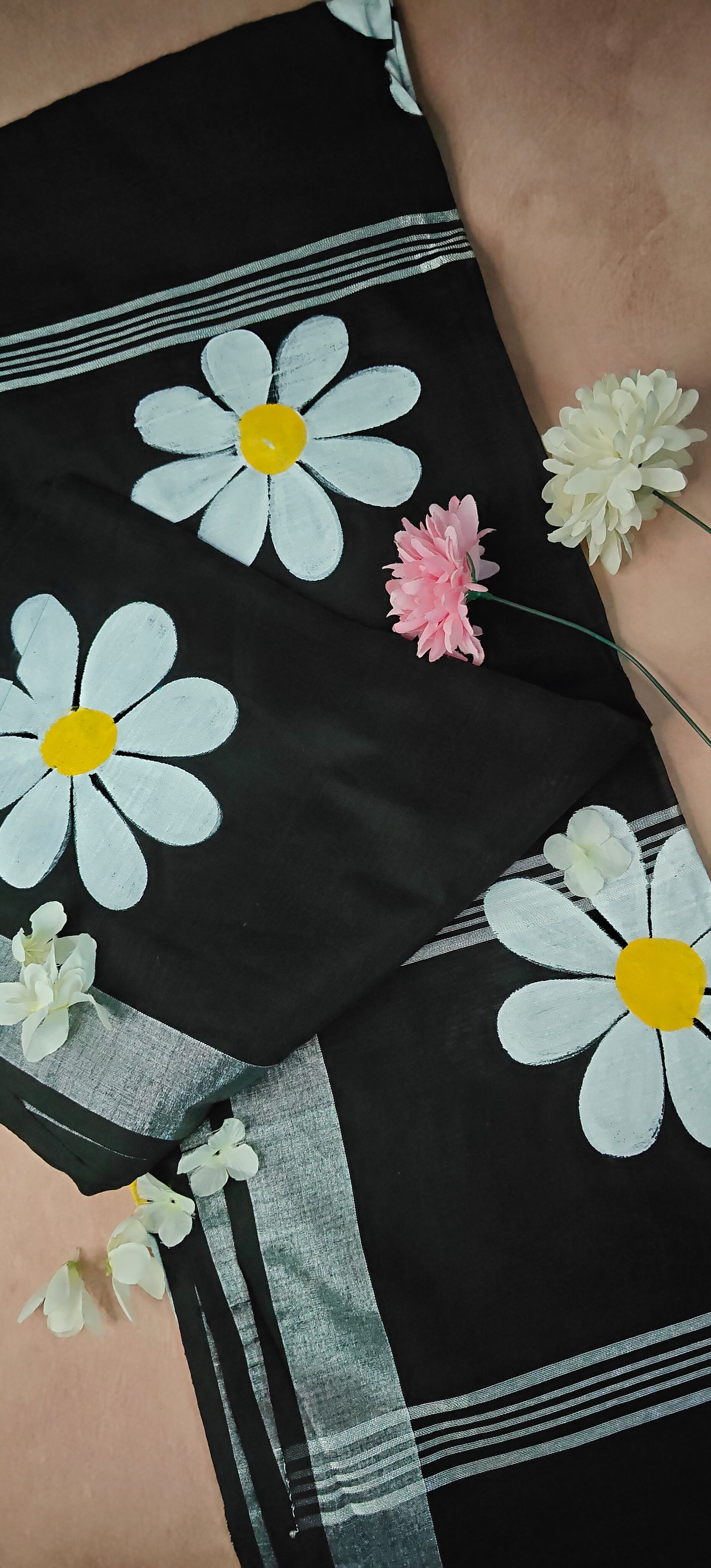 Black cotton saree with bold white sunflower motifs and yellow centers, handcrafted festive Indian saree.