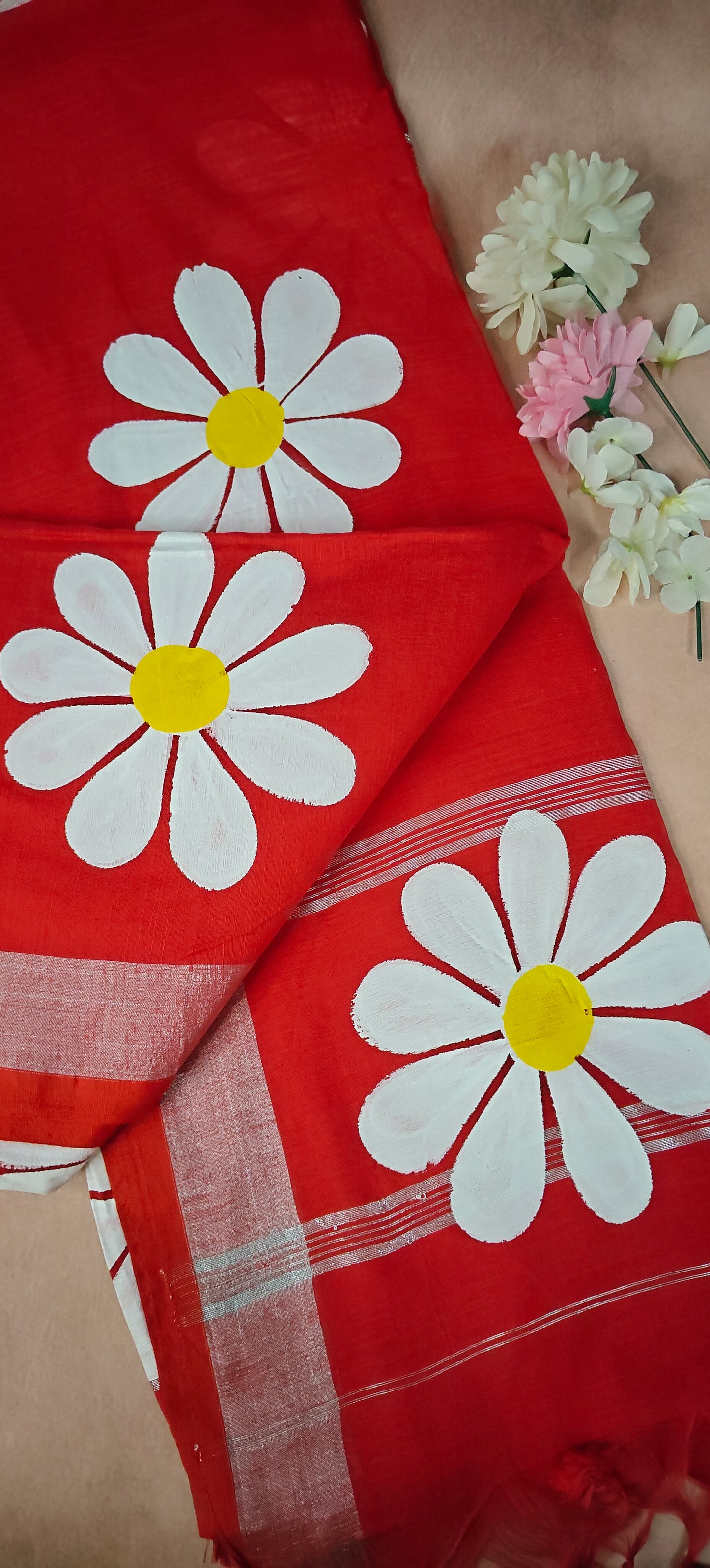 Red cotton saree featuring hand-painted sunflower design with white and yellow petals, artisan ethnic wear.