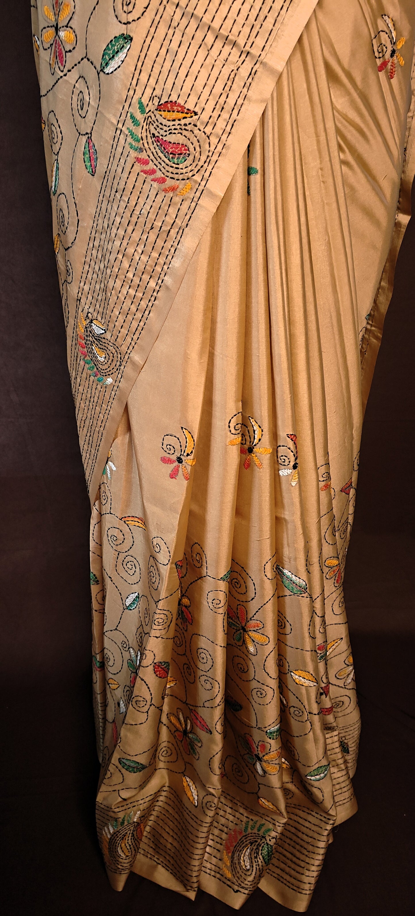Handcrafted Kantha-Stitched Cotton Saree – Gold with Multicolor Floral & Paisley Embroidery on a mannequin with dark background.