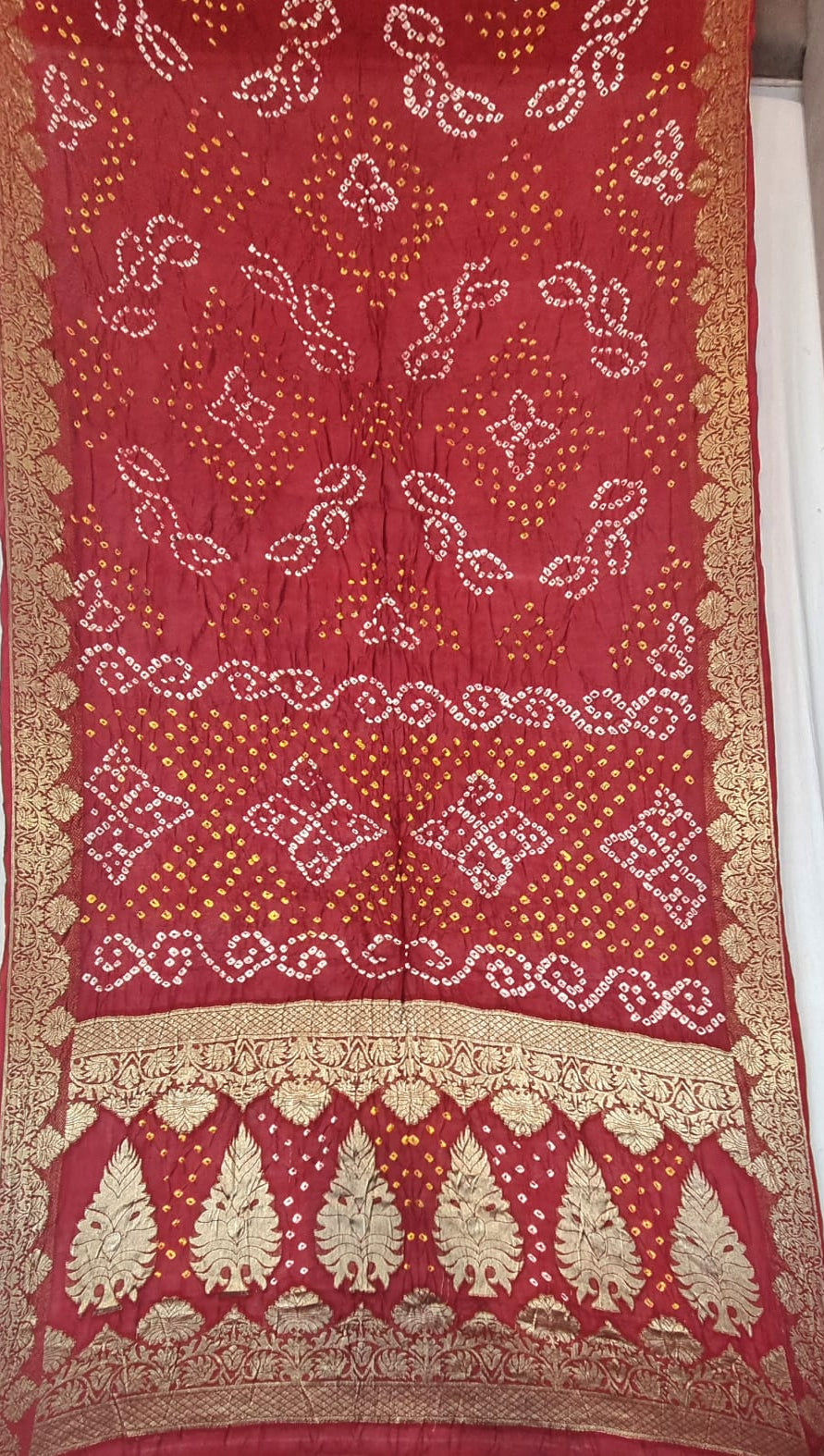 Art Silk Bandhani with Golden Zari - Red(bandhani) motifs and a wide gold border.