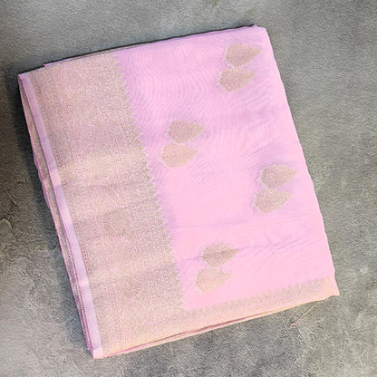 A folded Georgette Saree with Banarsi Border-Pink, displayed on a textured gray surface.