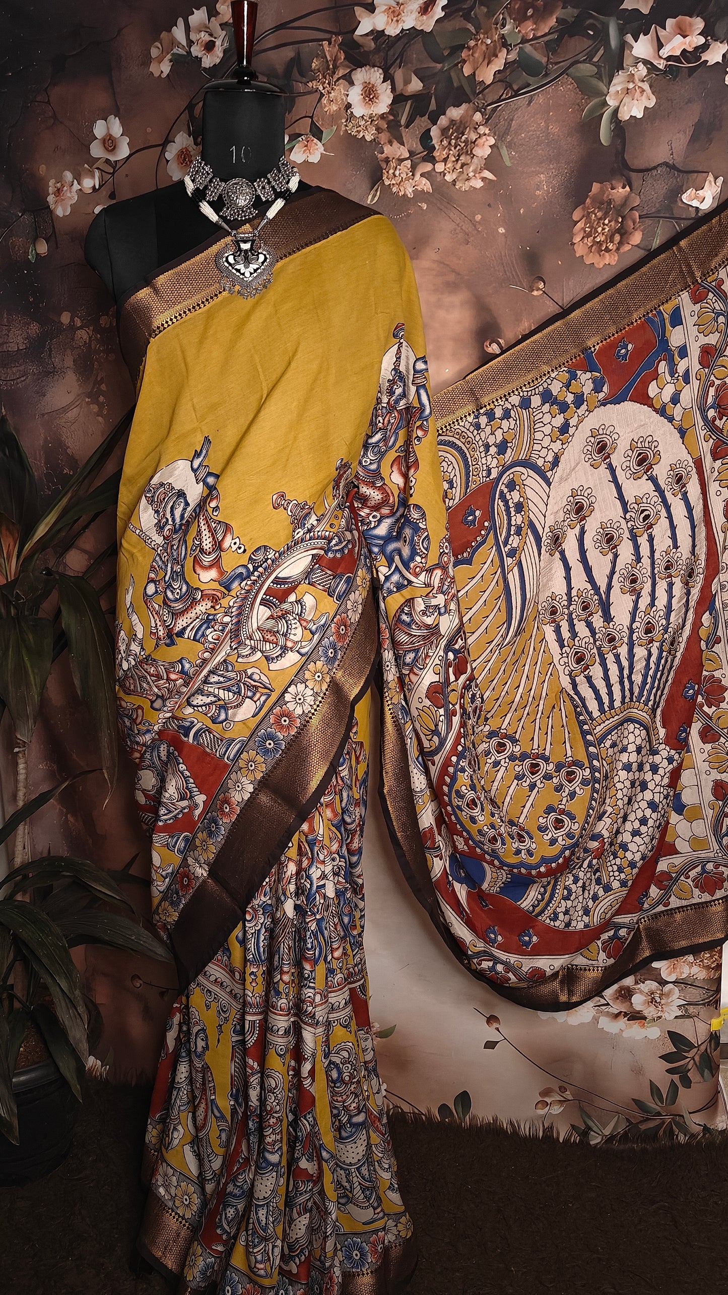 Handcrafted Mangalgiri Border Silk Saree with Temple Art Motifs-Yellow color saree with intricate patterns on a mannequin against a neutral background.