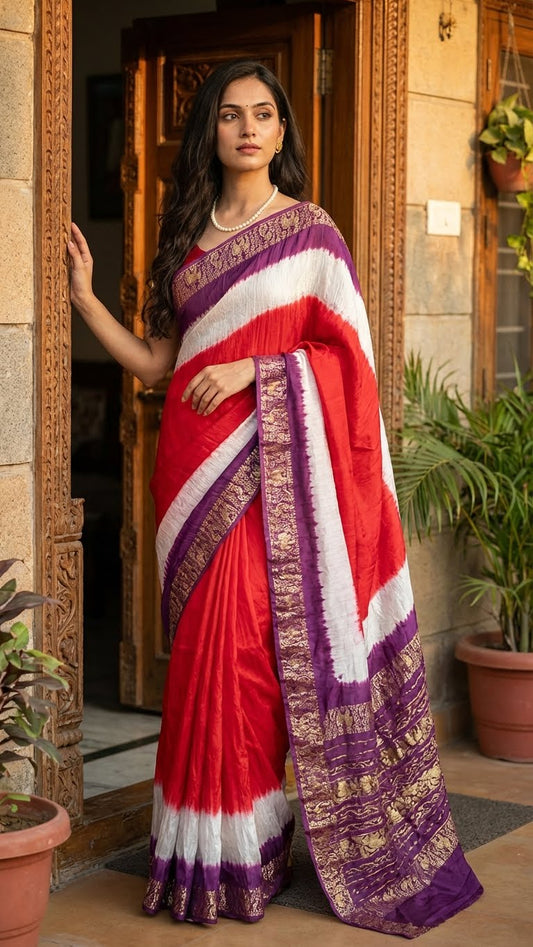 Woman wearing a magenta modal silk saree with purple zari border in an indoor setting.