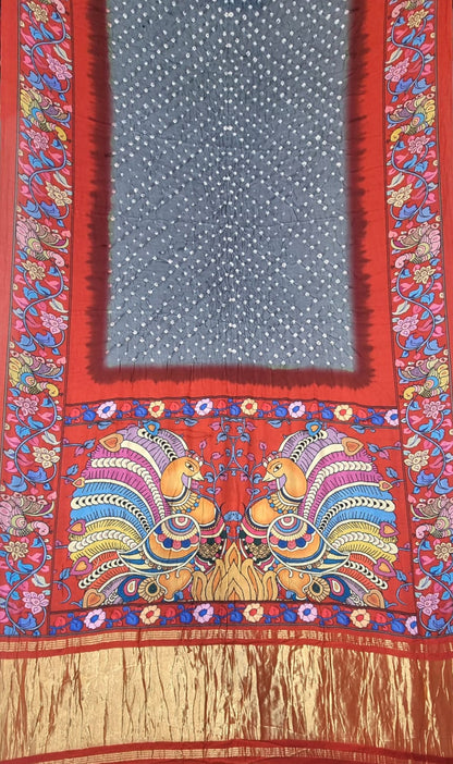 A Modal Silk with Bandhani Kalamkari Print Border - Grey with Red saree panel featuring a central blue-grey field with white dots, surrounded by a red border and decorated with colorful peacock motifs and gold Zari detailing.
