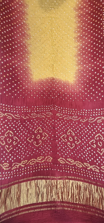 A close-up of a Modal Silk with Dual Shade Bandhani with Lagdi Patta - Beige/Maroon, featuring a large gold center panel, red border with white dotted motifs, and a gold zari border.