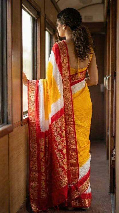 Woman wearing Mustard Yellow Modal Silk Saree with Red Zari Pallu – Traditional Indian Saree, standing by a train window.