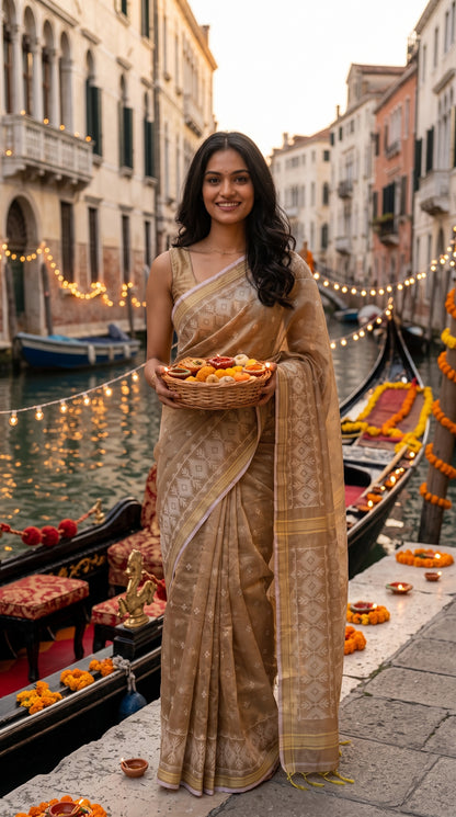 Full-length image of a woman standing by a Venetian canal decorated with string lights, holding a festive basket of sweets and diyas while displaying the elegant drape of a beige cotton tissue Jamdani saree