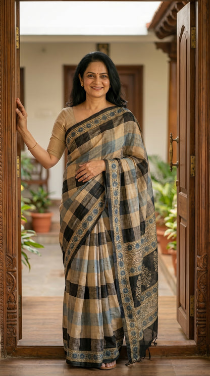Woman in a saree standing in a doorway with plants in the background