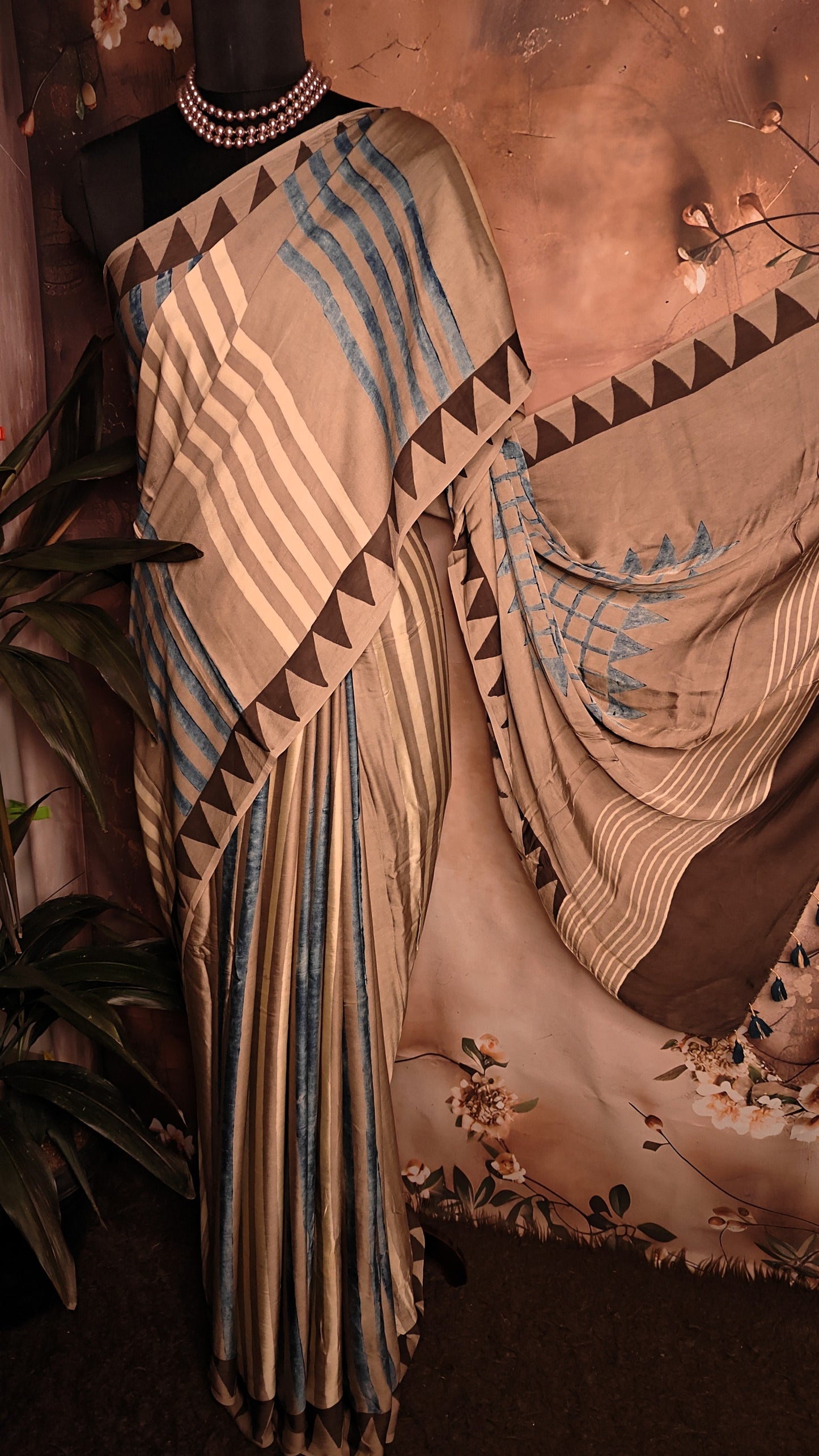 Ajrakh Modal Silk Saree – Beige & Brown with Blue Stripes and Triangular Border saree with geometric patterns on a mannequin.
