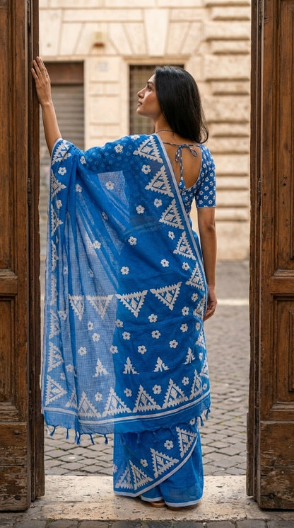 Woman in a blue-white-applique-kota-saree, standing in an outdoor setting.