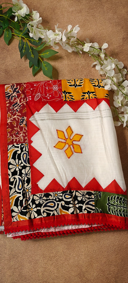White cotton saree with colorful appliqué patchwork and embroidered motifs, handcrafted traditional Indian attire.