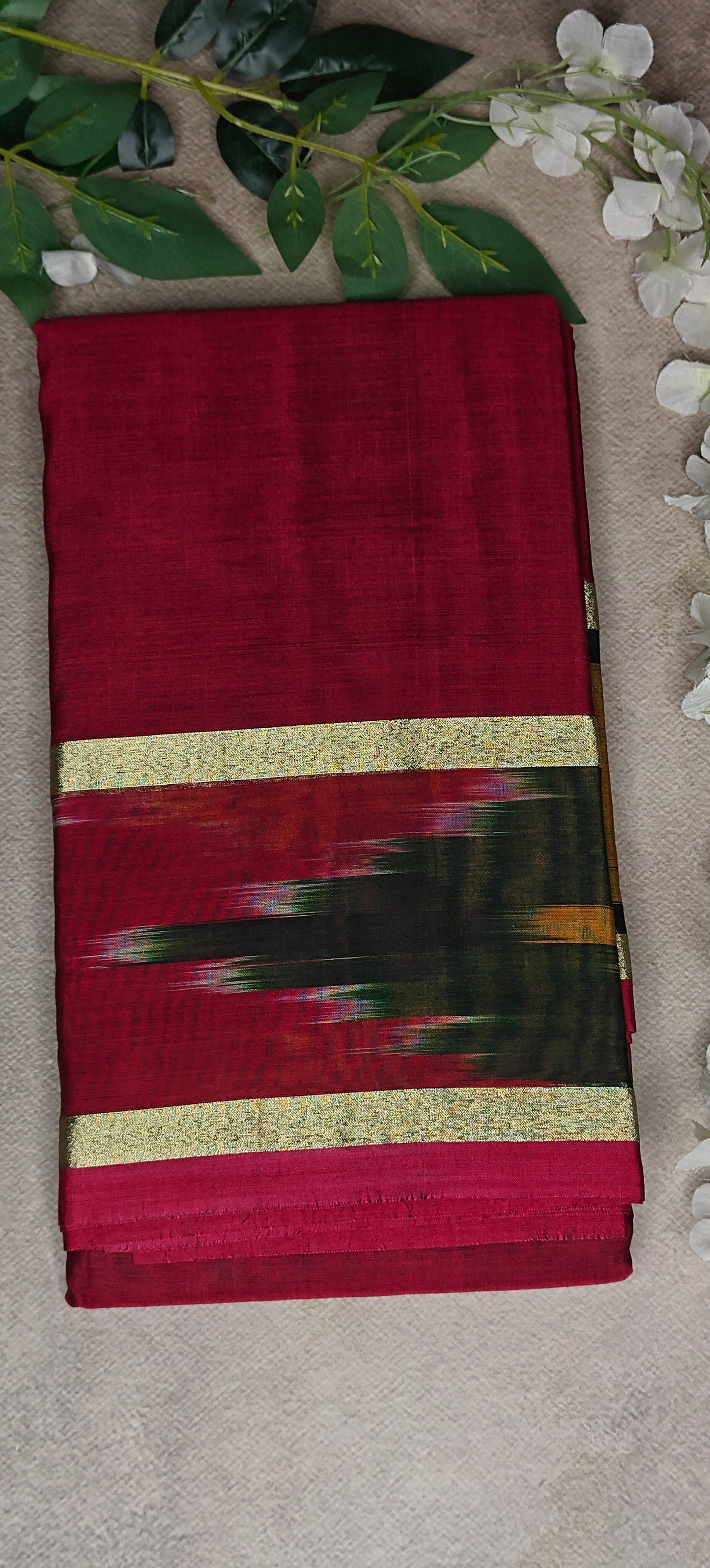 Wine cotton saree with abstract brushstroke border and golden trim, styled on mannequin with neutral background.