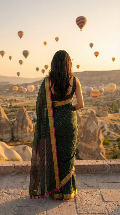 Woman in a dark-green-cotton-linen-saree-zari, watching hot air balloons in Cappadocia