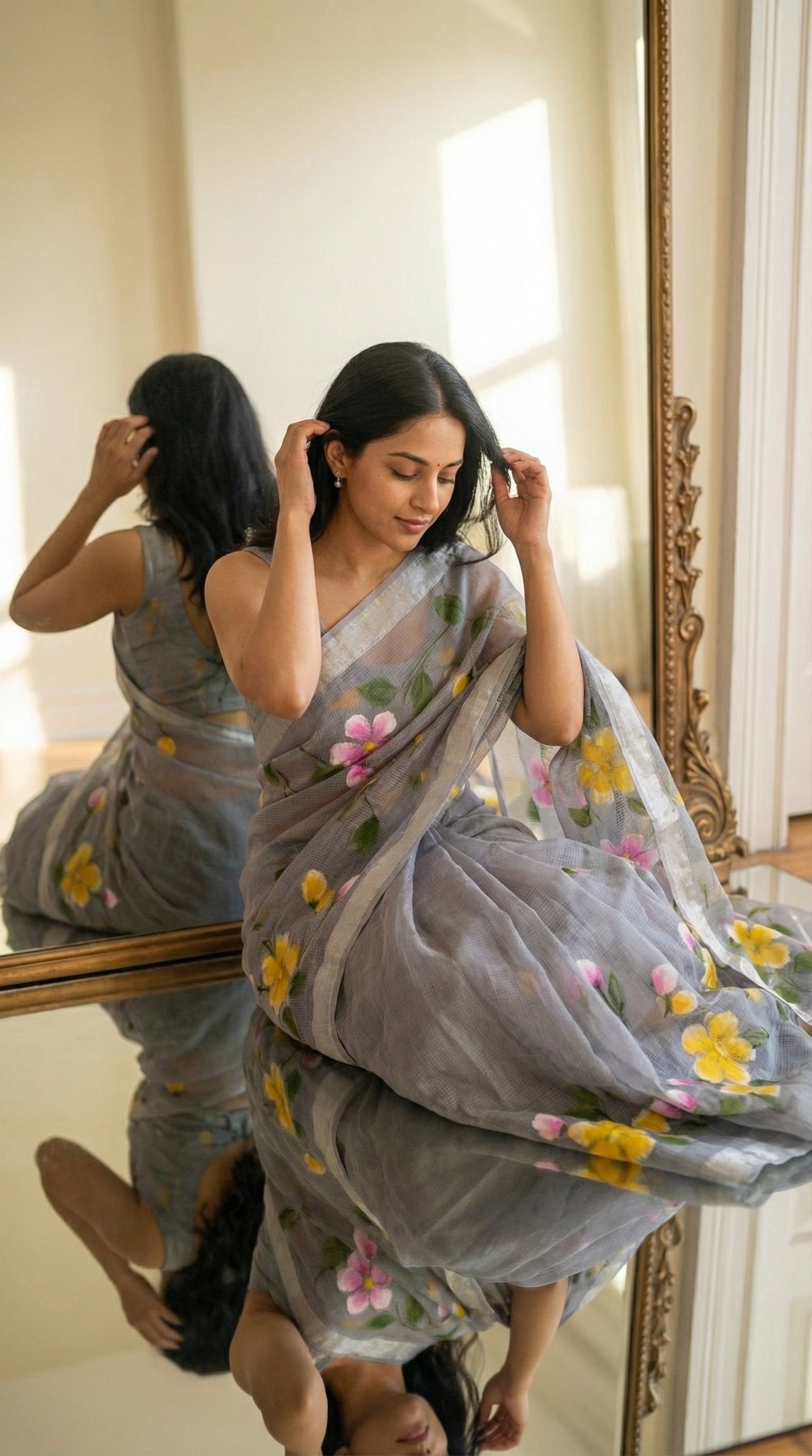Woman wearing a grey-kota-doria-floral-hand-painted-saree, standing in front of a mirror