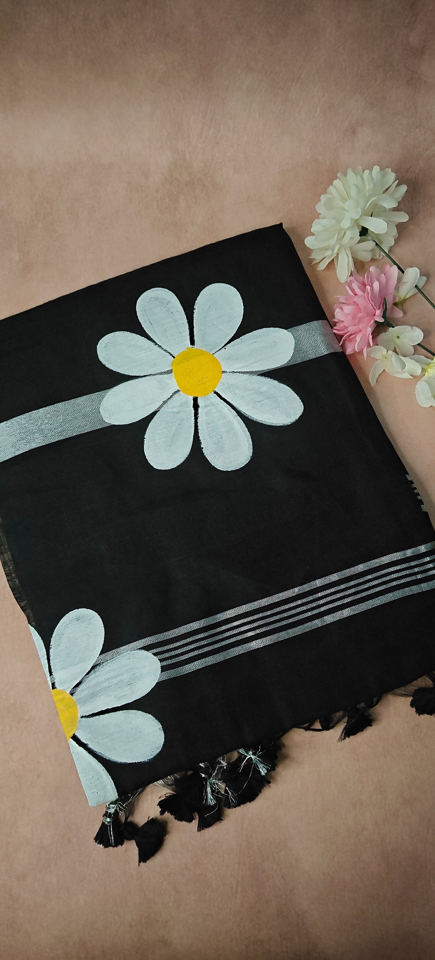 Black cotton saree with bold white sunflower motifs and yellow centers, handcrafted festive Indian saree.