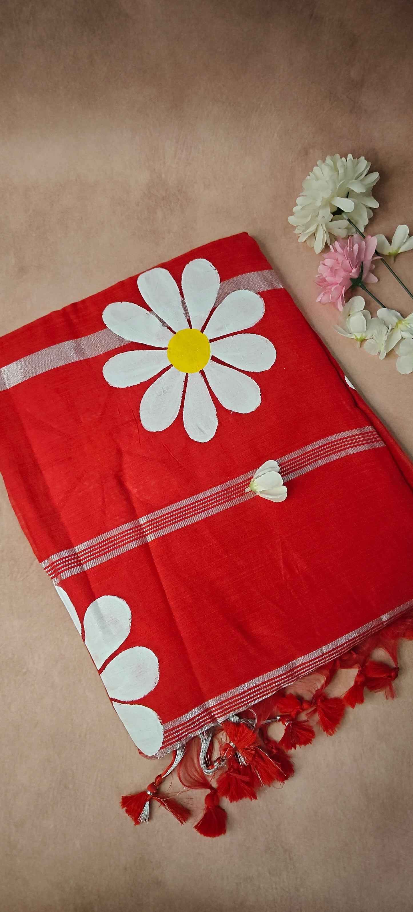 Red cotton saree featuring hand-painted sunflower design with white and yellow petals, artisan ethnic wear.