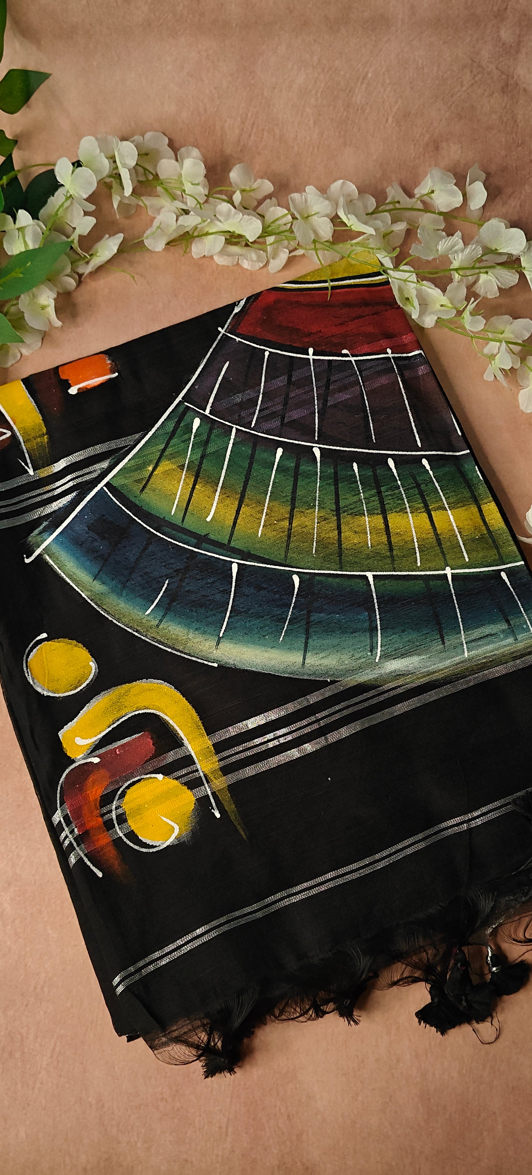 Black cotton saree featuring hand-painted tribal-inspired abstract face with geometric motifs, handcrafted Indian saree.