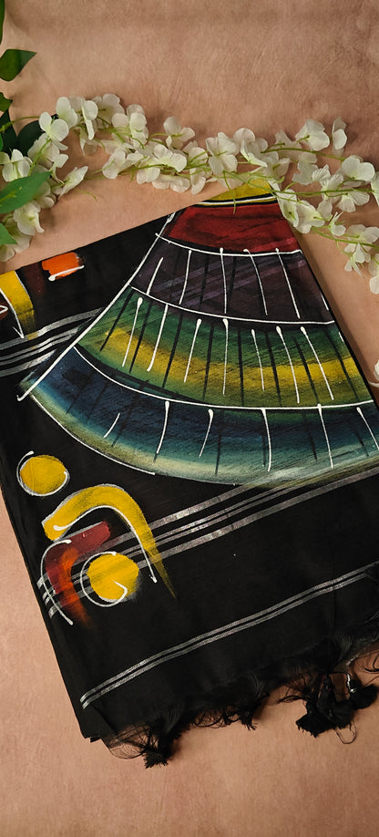 Black cotton saree featuring hand-painted tribal-inspired abstract face with geometric motifs, handcrafted Indian saree.