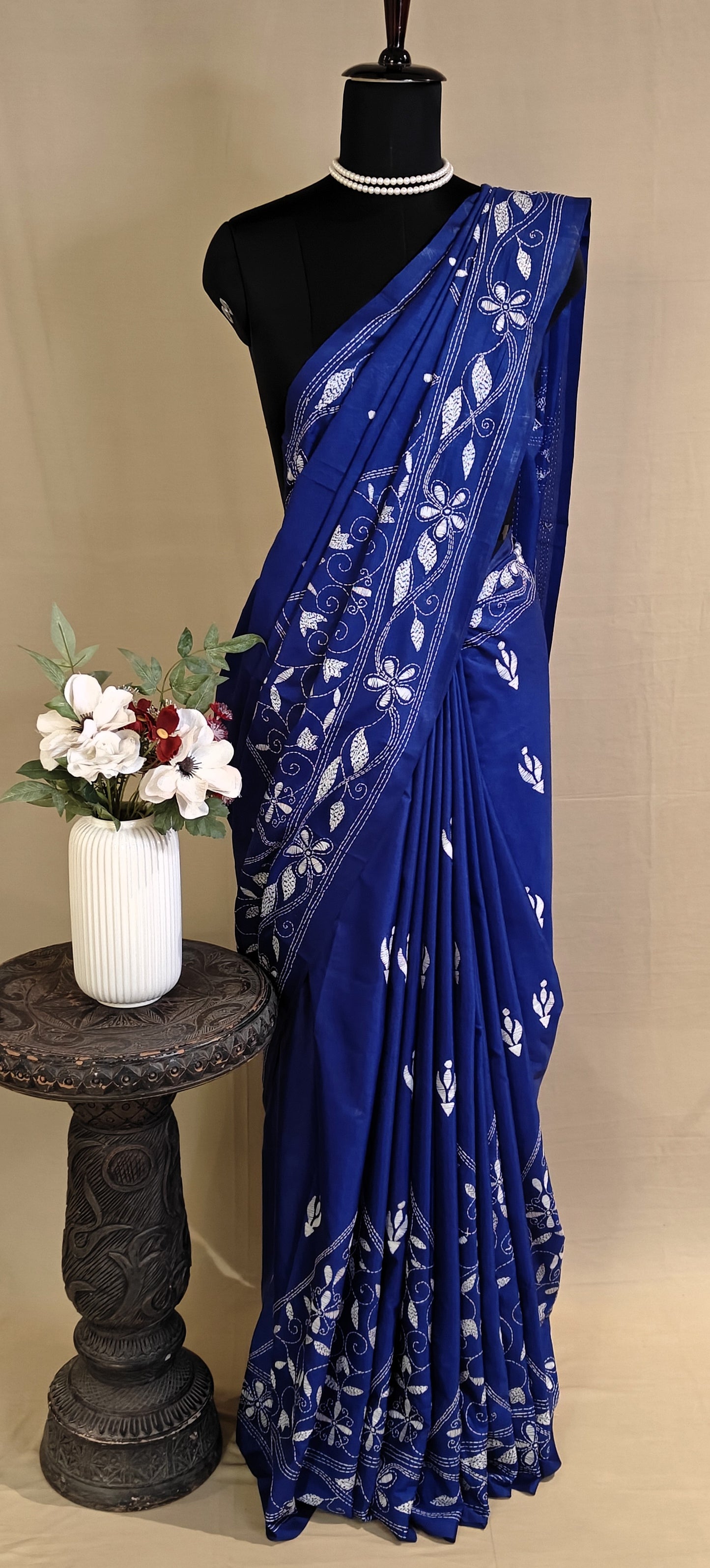 Handcrafted Kantha-Stitched blended silk Saree – Deep Blue with White Floral Embroidery saree on a mannequin with a beige background.