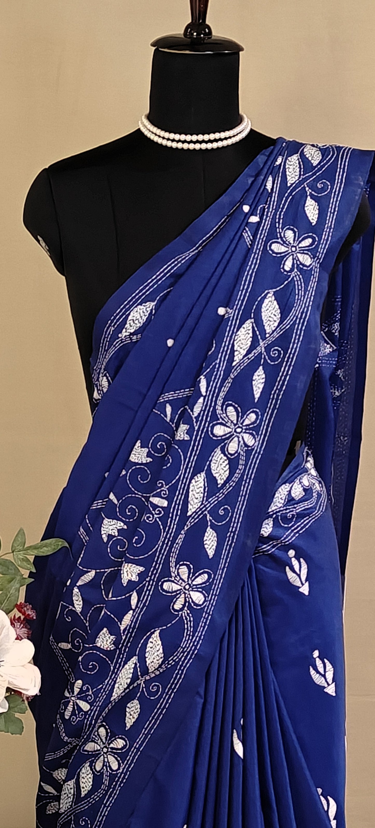 Handcrafted Kantha-Stitched blended silk Saree – Deep Blue with White Floral Embroidery saree on a mannequin with a beige background.
