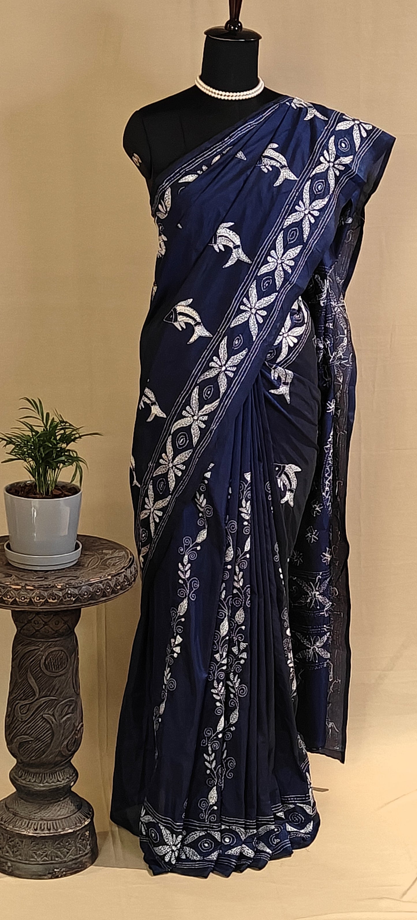 Handcrafted Kantha-Stitched Cotton Saree – Indigo Blue with White Bird & Floral Motifs saree with white patterns on a mannequin against a beige background.