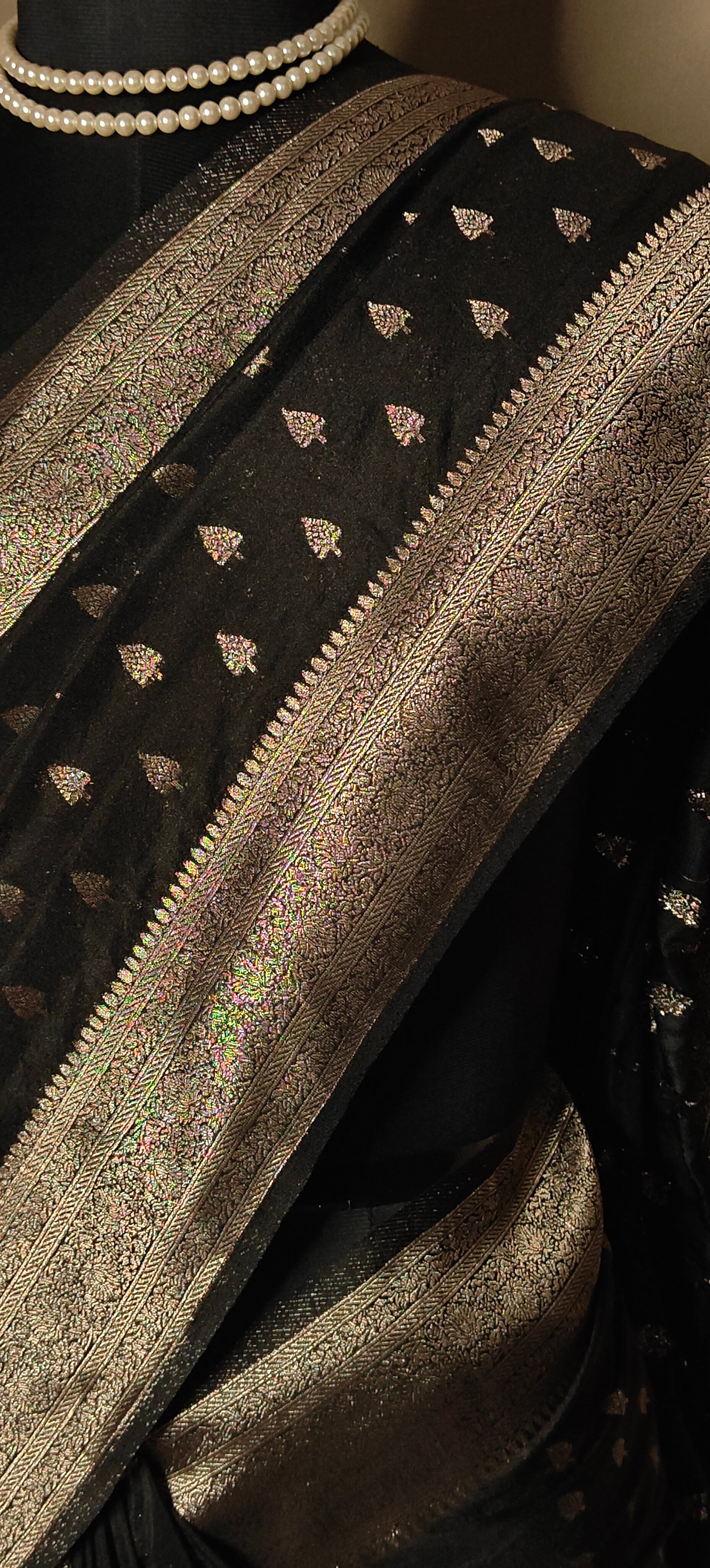 Black blended silk saree with silver Khaddi Butti motifs and rich border, displayed on mannequin.