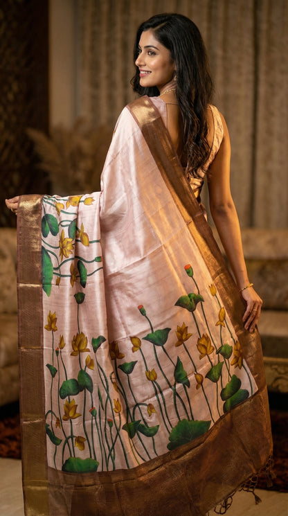 Woman in a traditional light-pink-viscose-silk-lotus-saree, in a decorated room.