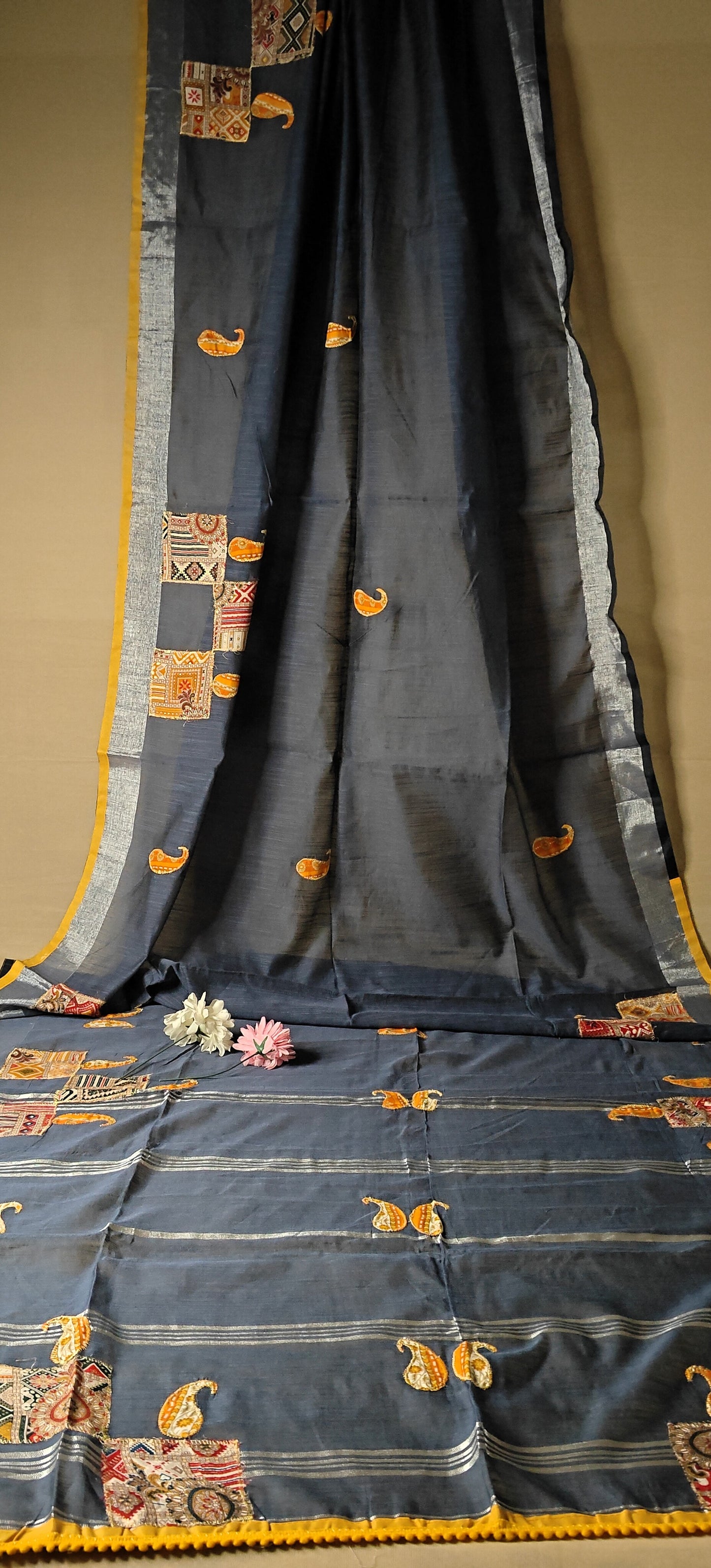 Grey linen cotton saree with applique work paisley motifs and silver thread detailing, breathable ethnic wear.