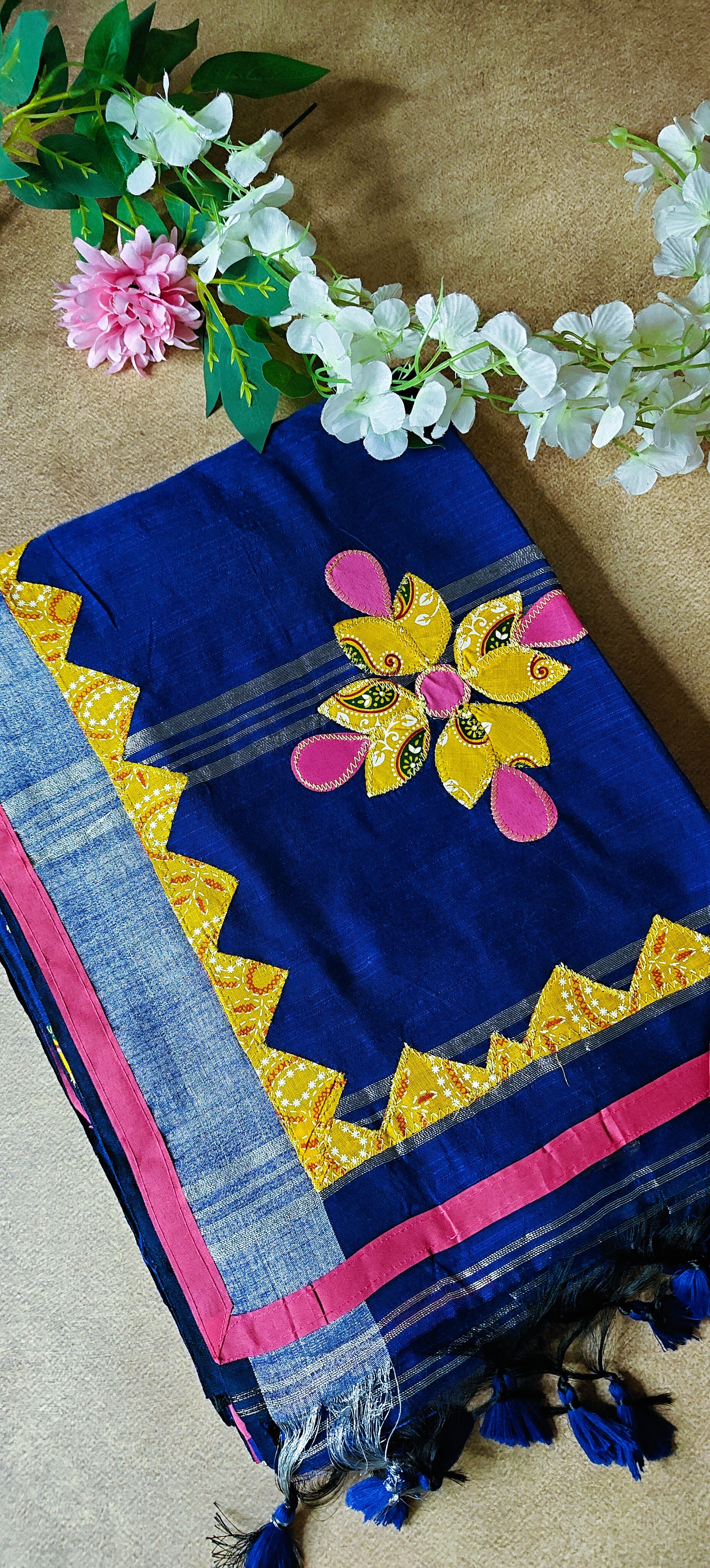 Navy linen cotton saree with multicolor floral appliqué and hand embroidery, artisan-crafted traditional Indian saree.