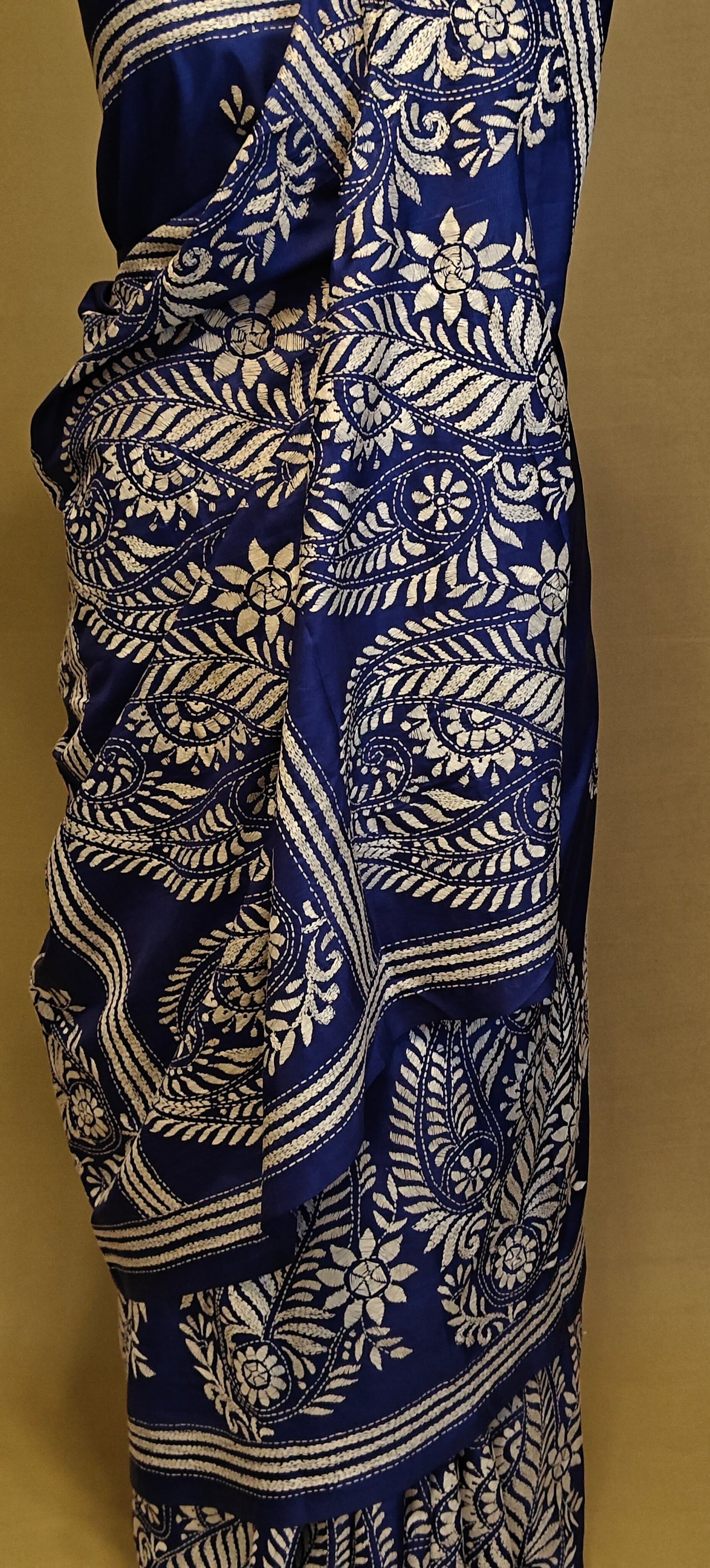 Luxury Kantha-Stitched Silk Saree – Deep Blue with White Paisley & Floral Bands saree on a mannequin with neutral background.