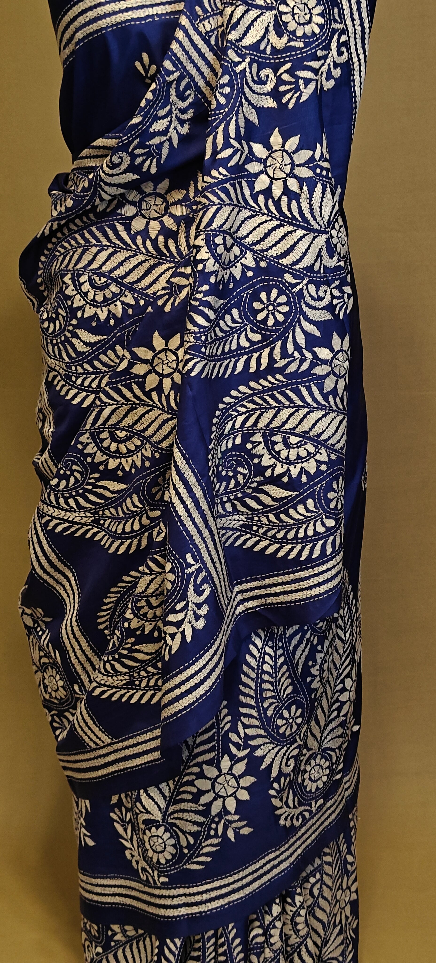 Luxury Kantha-Stitched Silk Saree – Deep Blue with White Paisley & Floral Bands saree on a mannequin with neutral background.