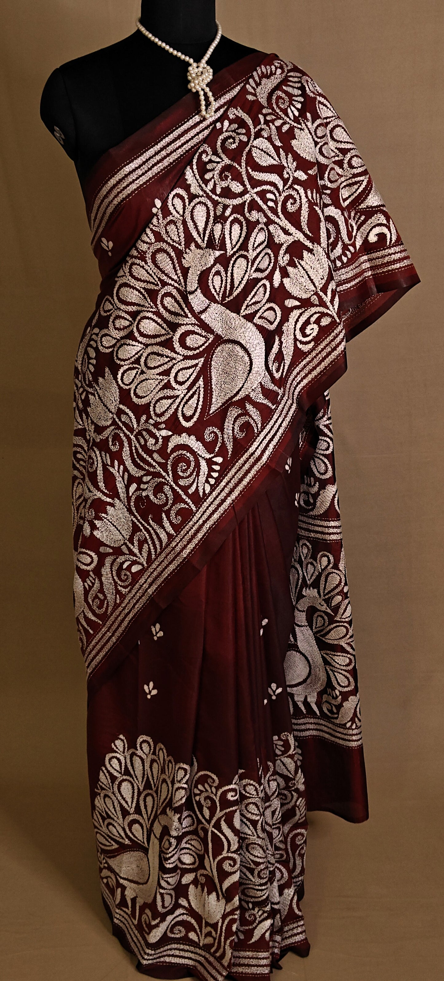 Luxury Kantha-Stitched Silk Saree – Red with Intricate Peacock & Floral Motifs saree draped on a mannequin.