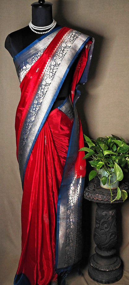 Magenta Mashru silk saree with silver-blue ornate border, styled on mannequin.