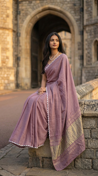 Woman in a mauve-modal-silk-saree-lagdi-patta-pallu, sitting outdoors