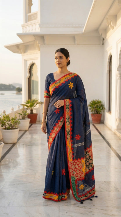 Woman in a navy blue linen cotton saree with traditional handcrafted applique border, on a rooftop.