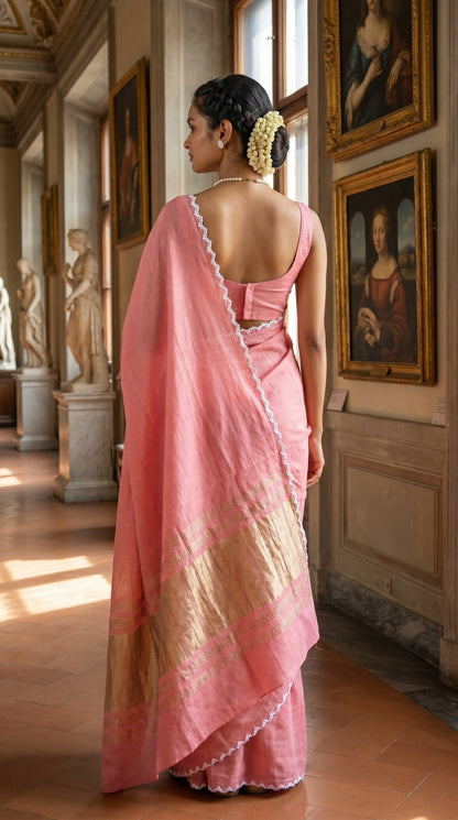 Woman in a pink saree standing in an art gallery with paintings on the walls.