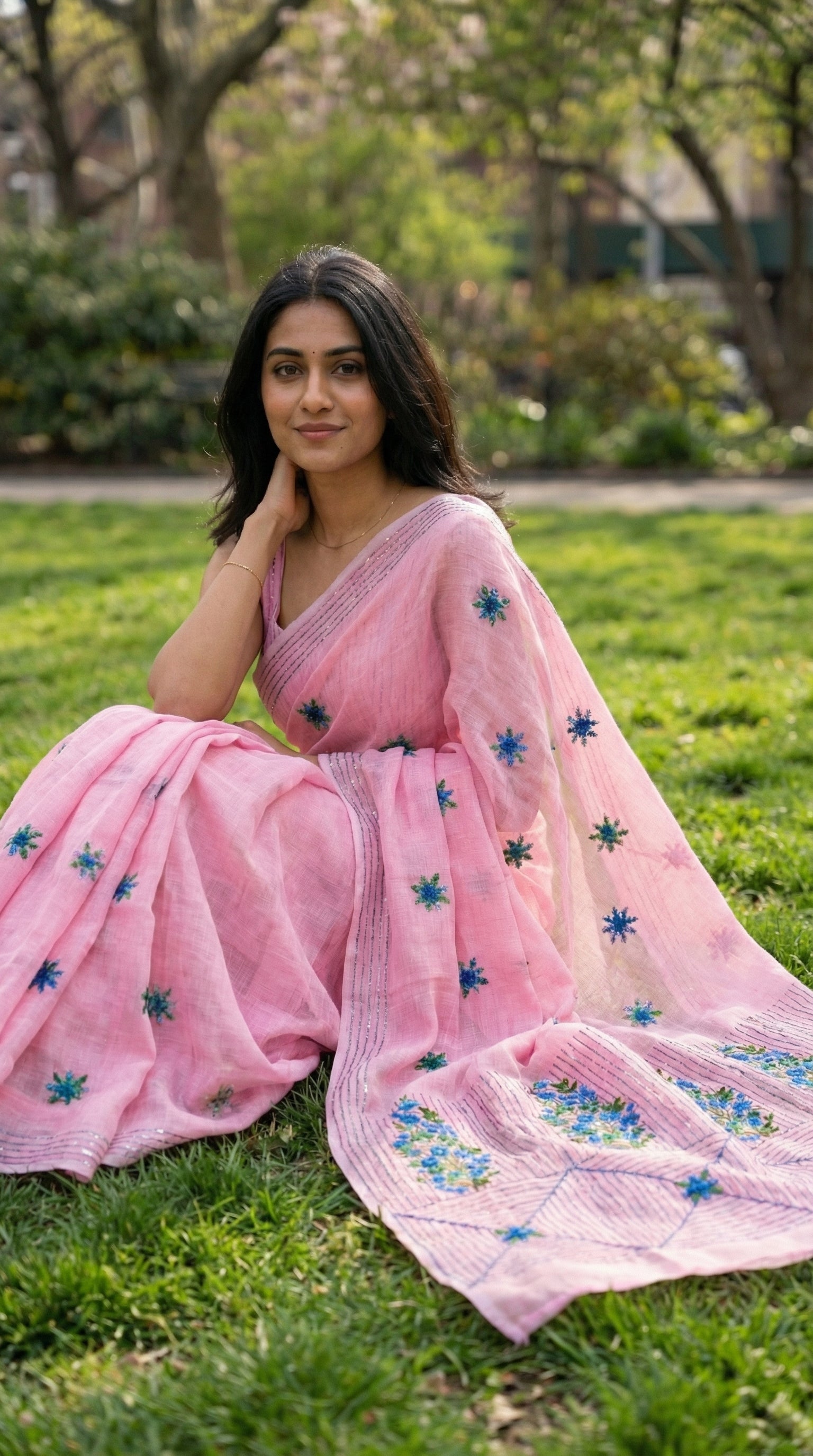 Woman in a pink-chanderi-kantha-saree, sitting on grass
