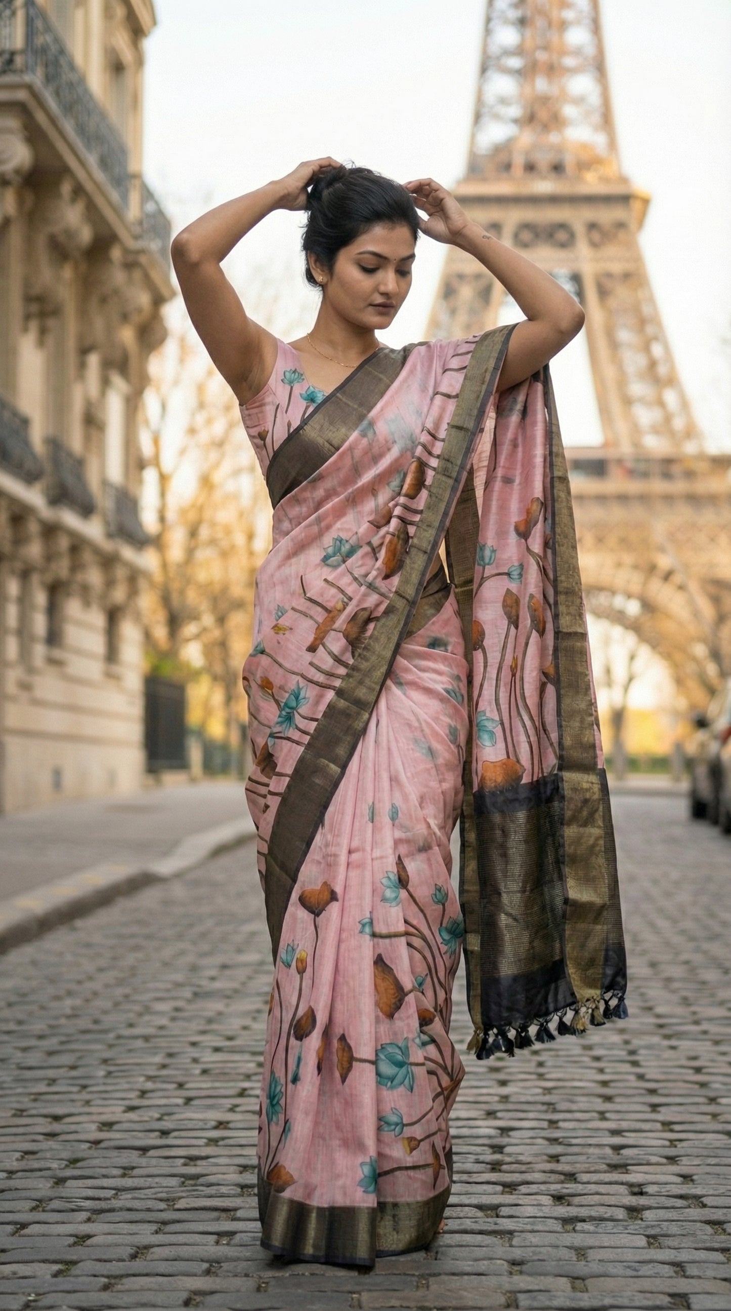 Woman in a pink-viscose-silk-grey-floral-saree, standing in front of the Eiffel Tower.
