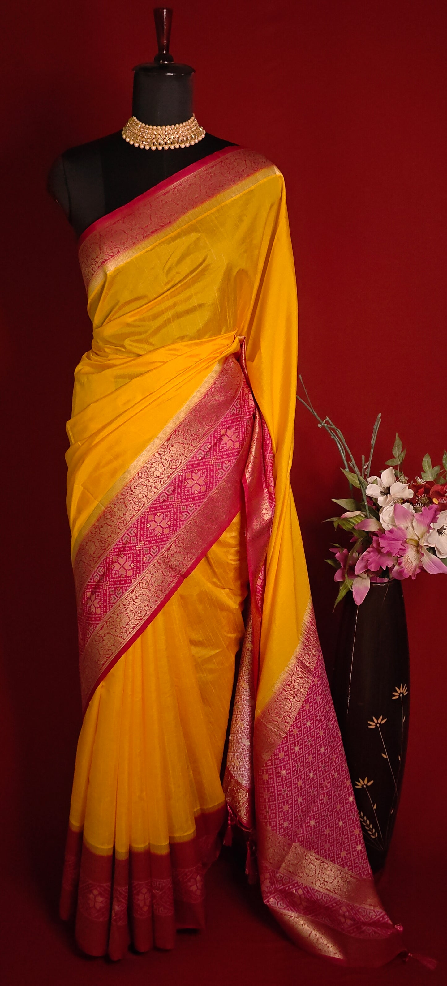 Bright yellow Pochampally silk saree with geometric ikat patterns and rich gold zari border.