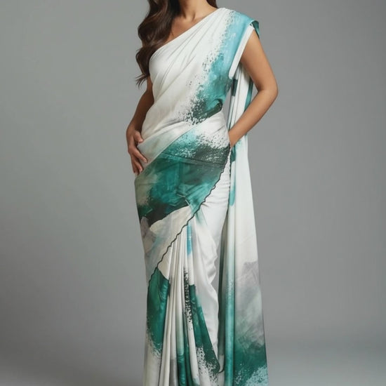 Lady wearing green satin-georgette saree with expressive brushstroke motifs and scalloped border, modern ethnic saree for cultural occasions against grey background.
