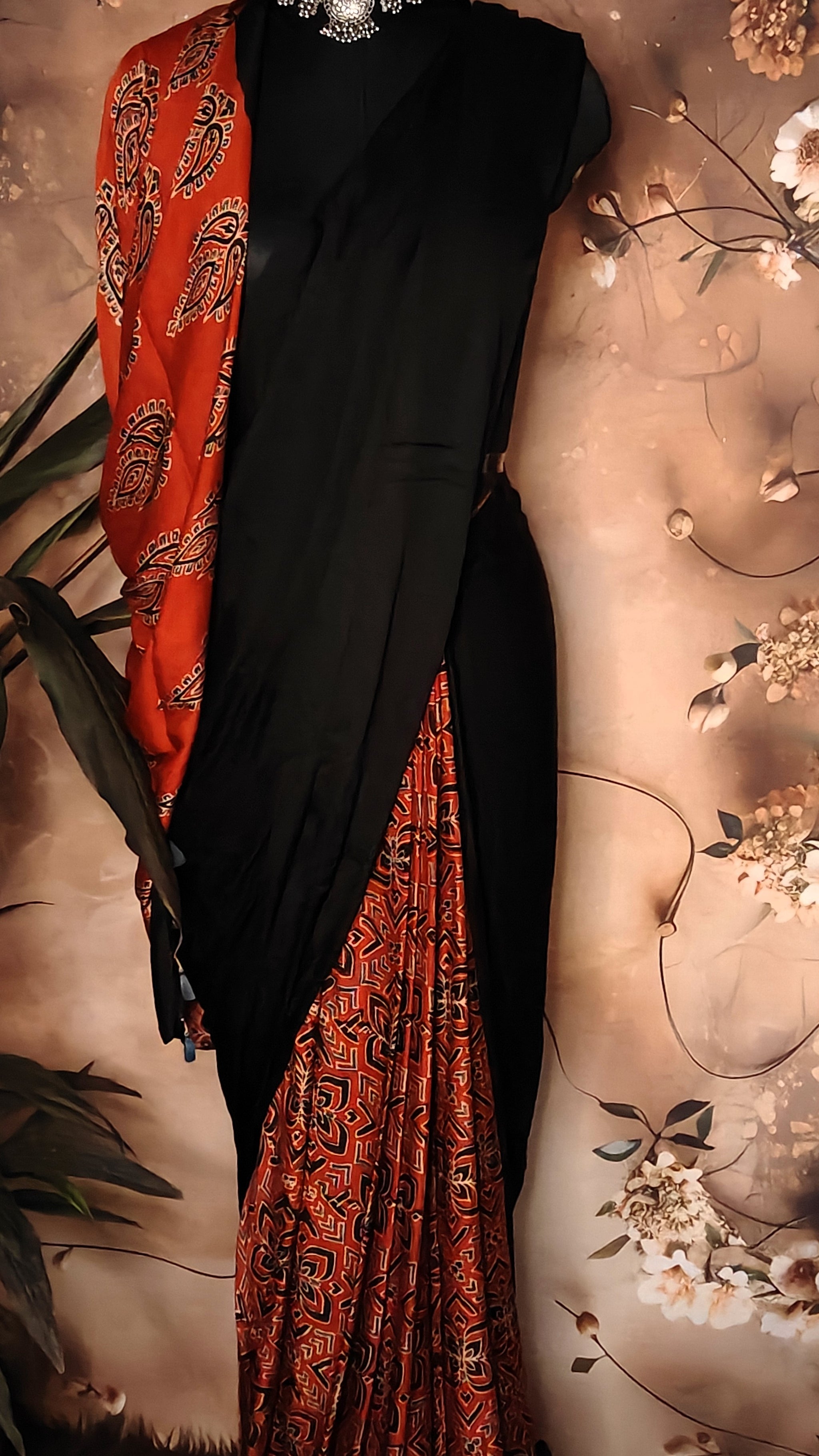Ajrakh Modal Silk Saree – Black with Red Tribal Motif Pallu and Geometric Pleats saree draped on a mannequin.