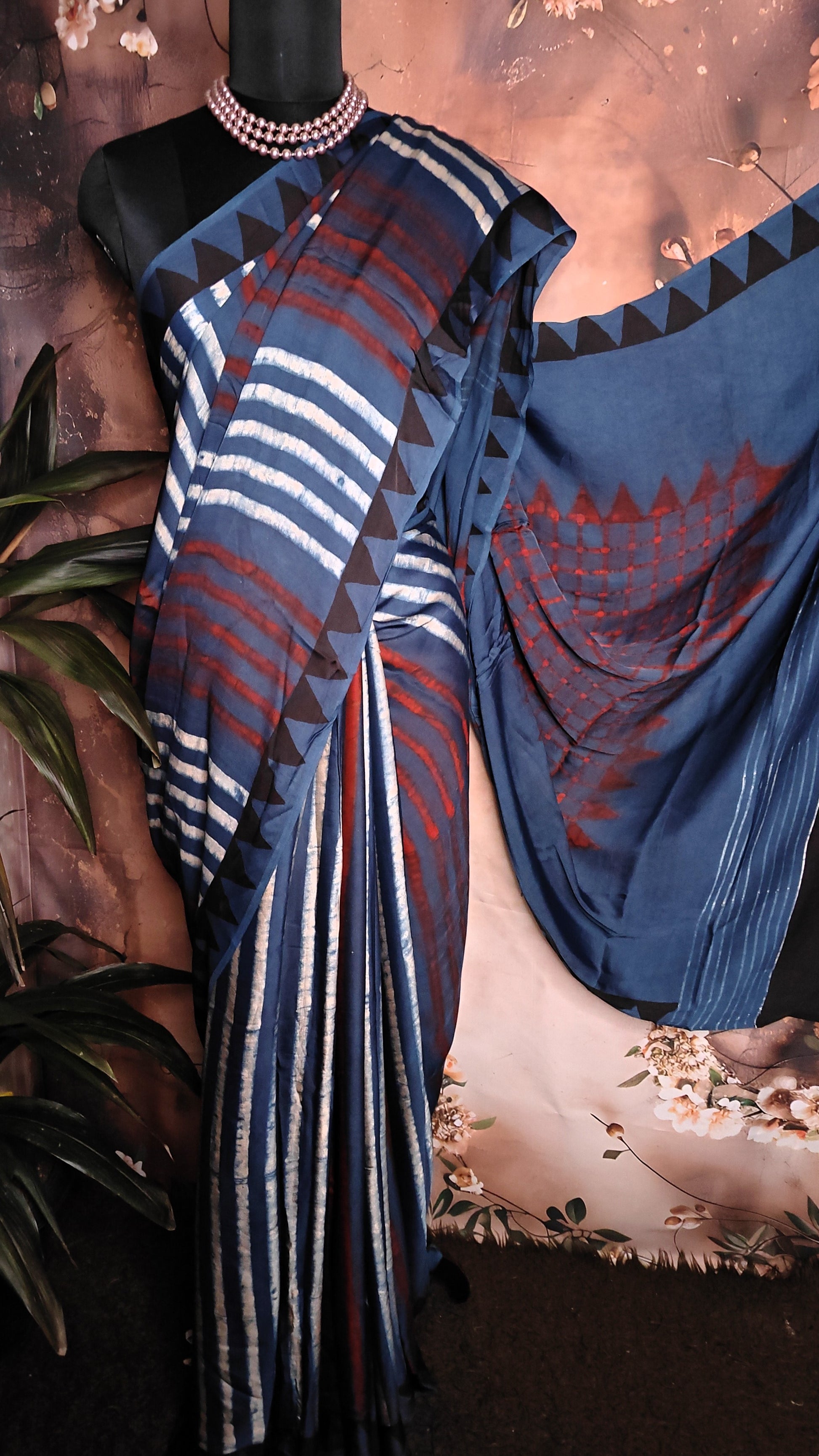 Ajrakh Modal Silk Saree – Deep Blue with Maroon Chevron & Triangular Border Motifs saree draped over a mannequin.