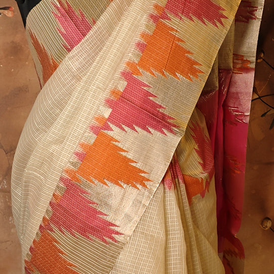 Kota Blend Saree – Cream Base with Vibrant Zigzag Pallu saree on a mannequin against a floral background.