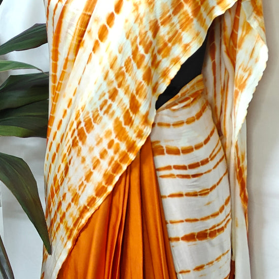 Designer Modal Silk Saree – Bandhani Print in Orange & White with Shibori Pallu saree on a mannequin.