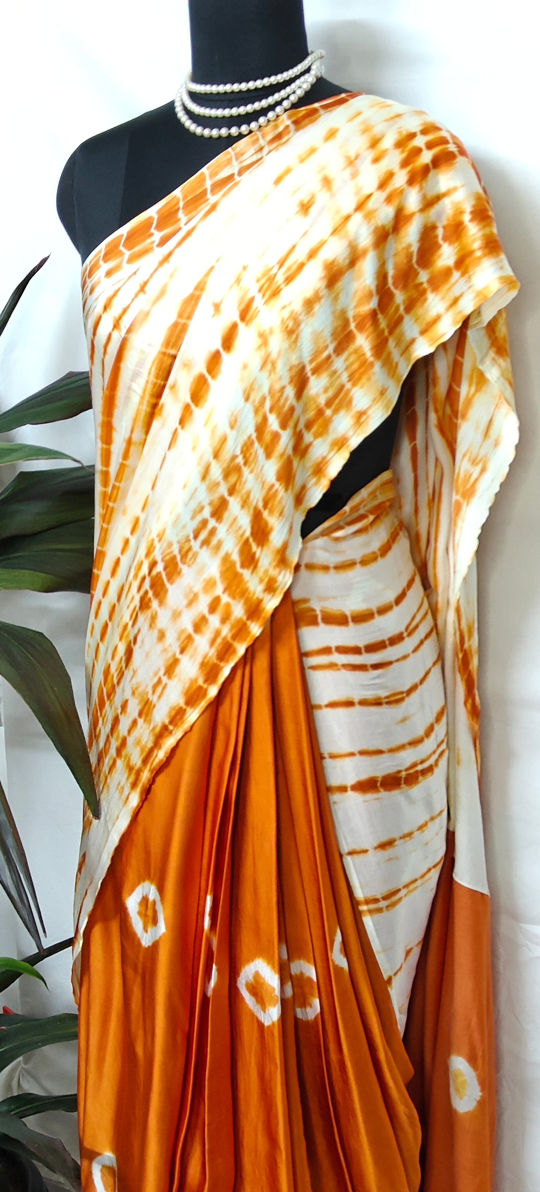 Designer Modal Silk Saree – Bandhani Print in Orange & White with Shibori Pallu saree on a mannequin.