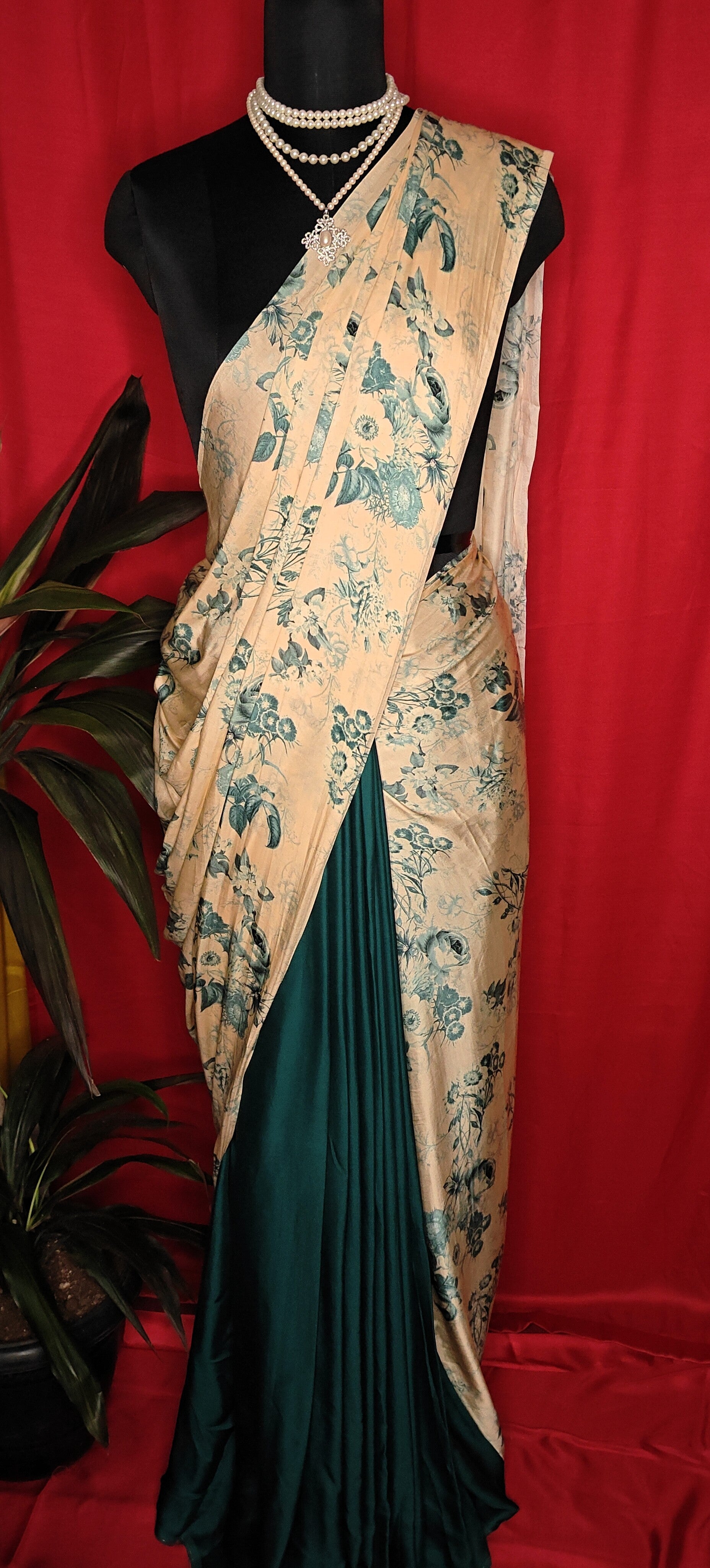 Designer Modal Silk Saree – Beige & Deep Green with Floral Print and Dual-Tone Drape saree draped on a mannequin.
