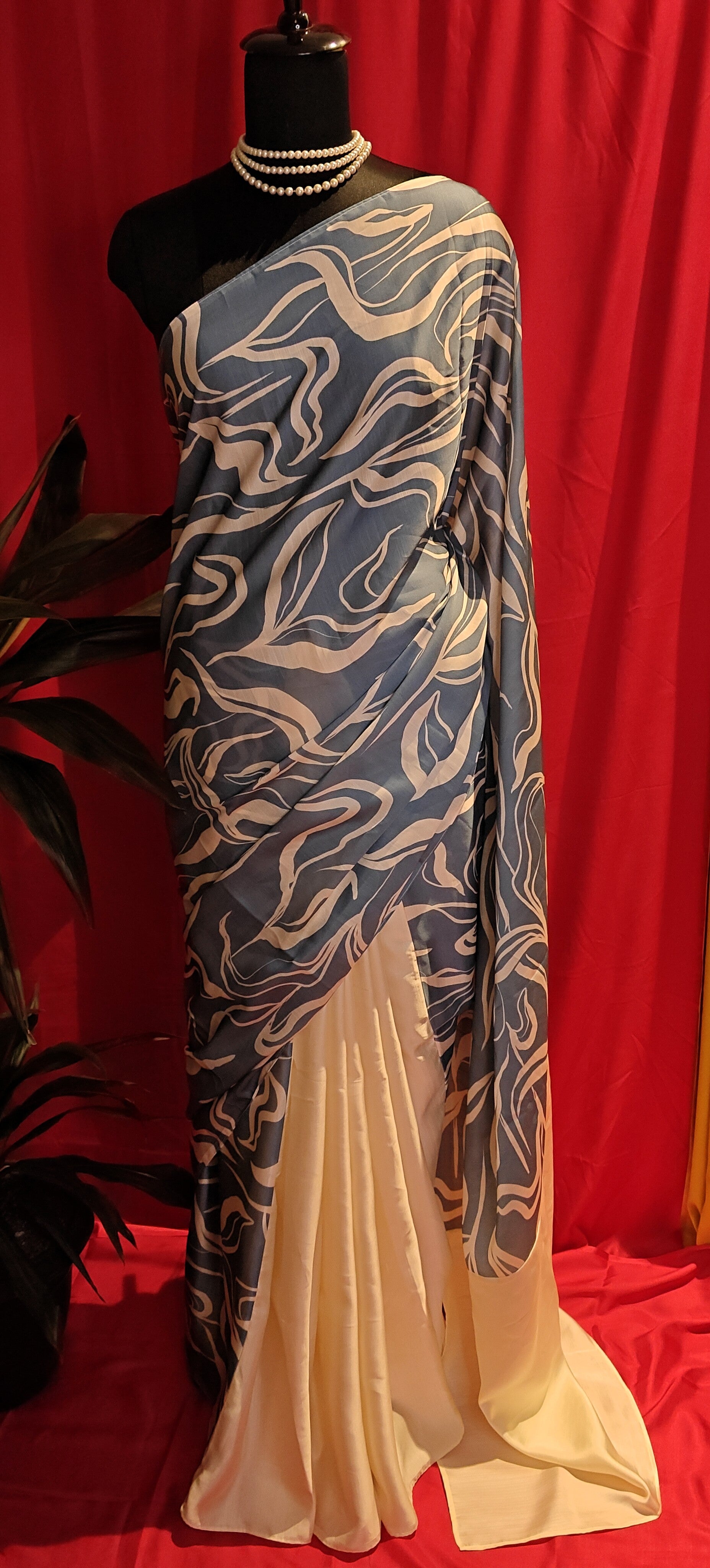 Designer Silk Saree – Blue Abstract Print with Cream Pallu saree draped on a mannequin.