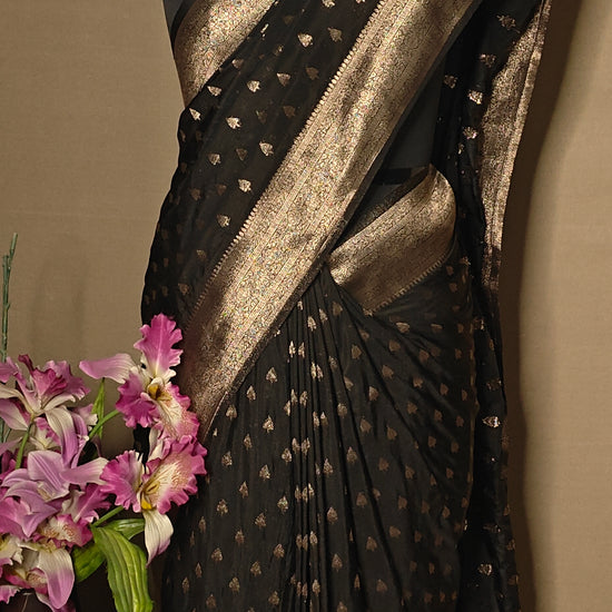Black blended silk saree with silver Khaddi Butti motifs and rich border, displayed on mannequin.