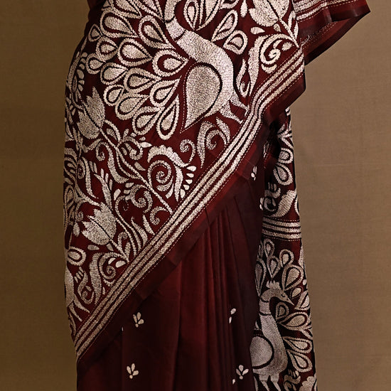Luxury Kantha-Stitched Silk Saree – Red with Intricate Peacock & Floral Motifs saree draped on a mannequin.